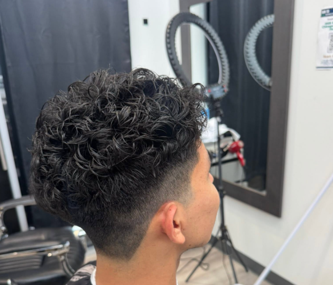 Client with curly textured fade haircut